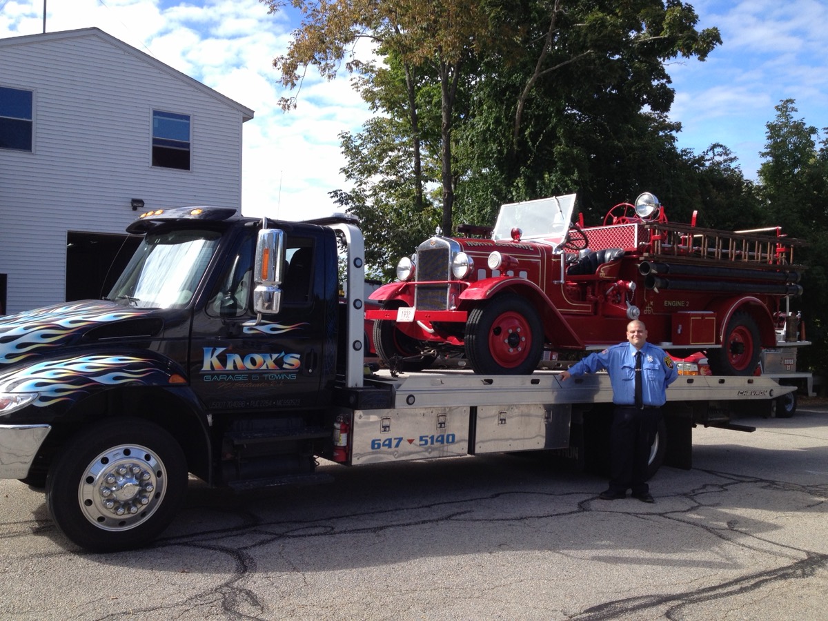 Antique North Scituate fire engine loaded on a Knox's flatbed