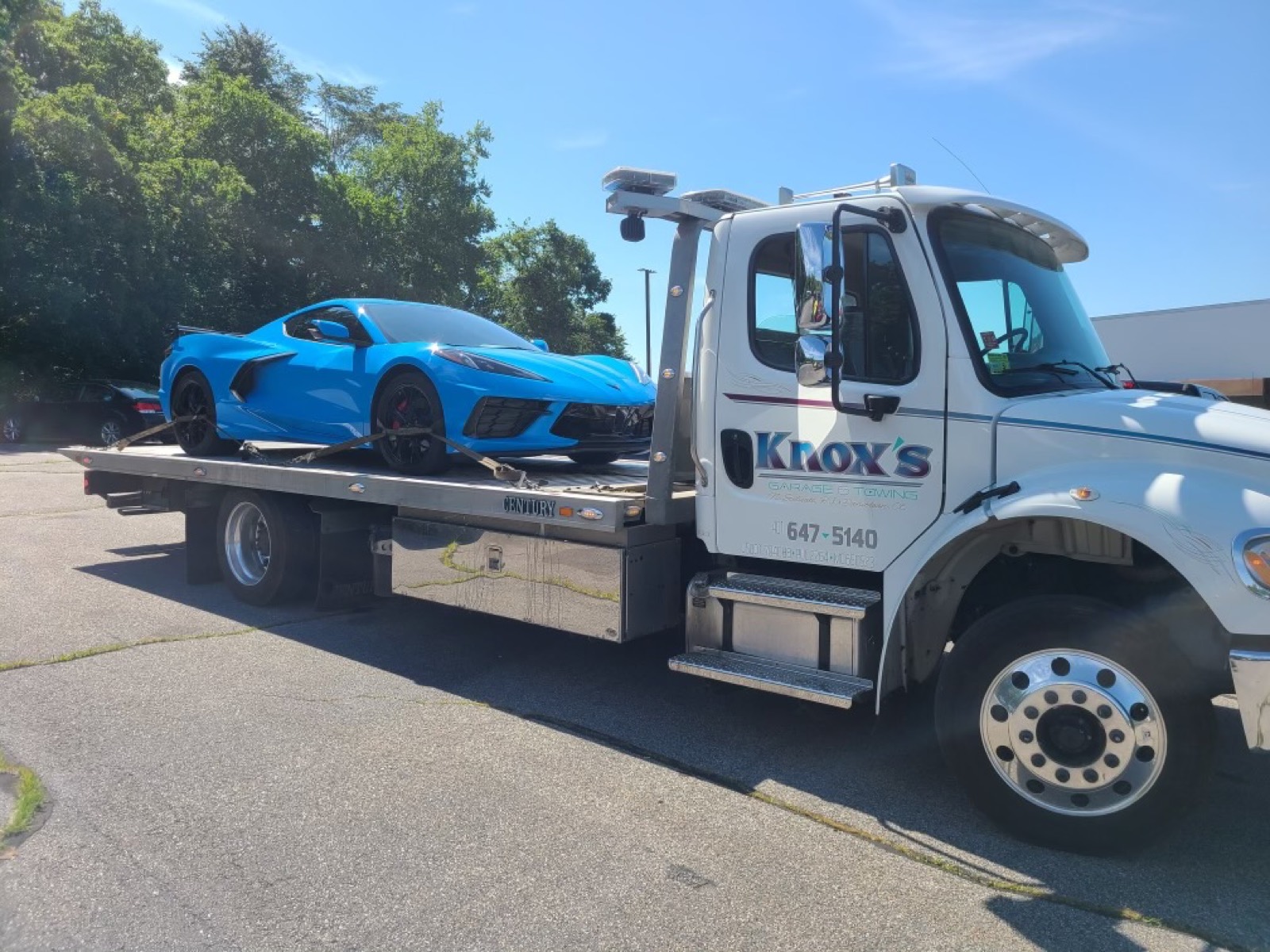 Knox's flatbed carrier hauling a sports car