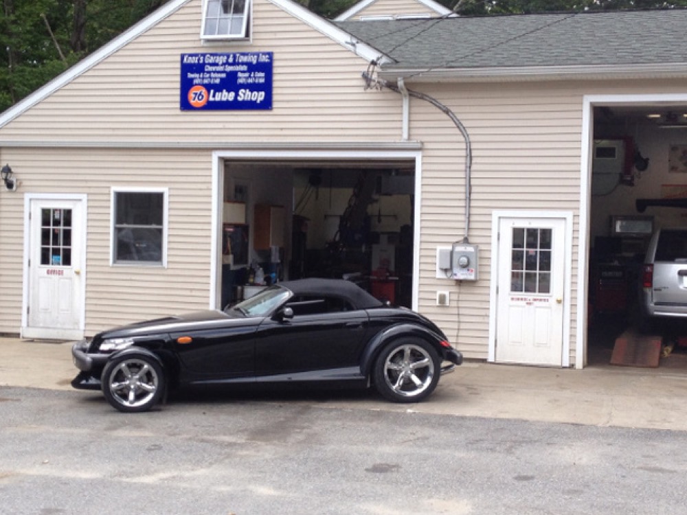 A Plymouth Prowler outside the Knox's Garage repair bays