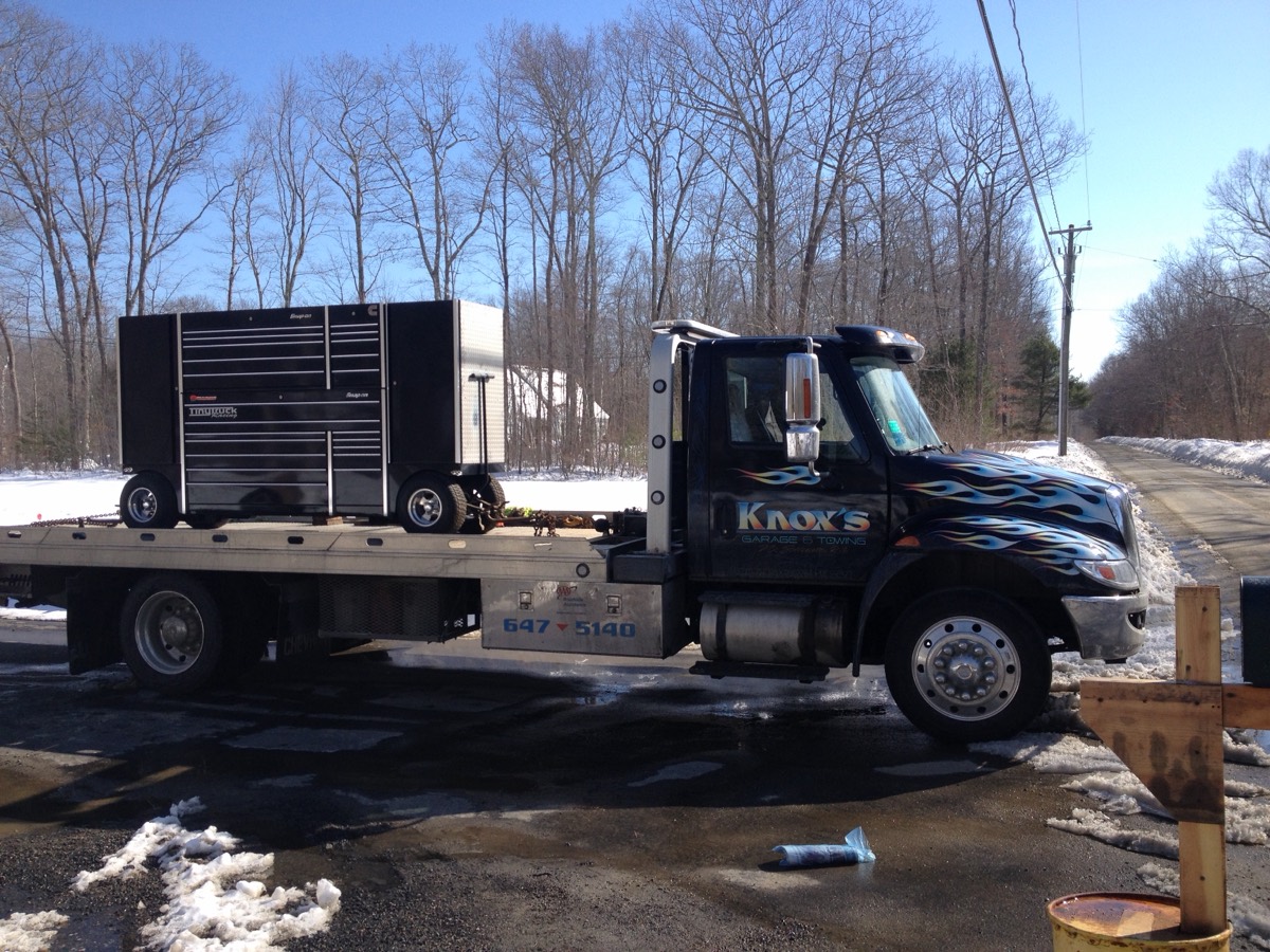 Knox's flatbed carrier hauling a large tool chest